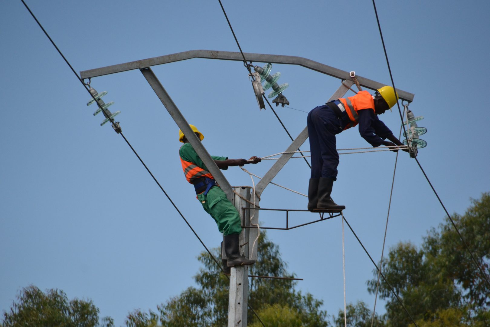 Two men work on some power lines