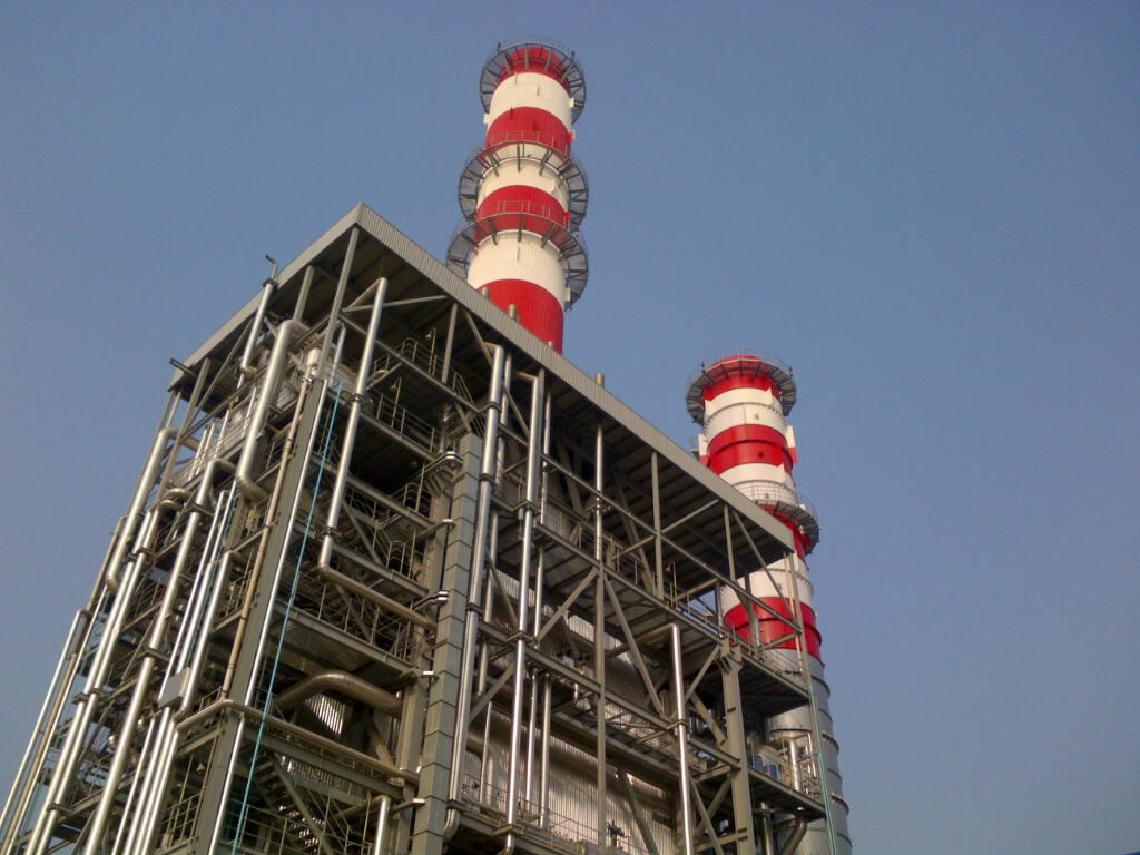 Power station with red and white towers on top