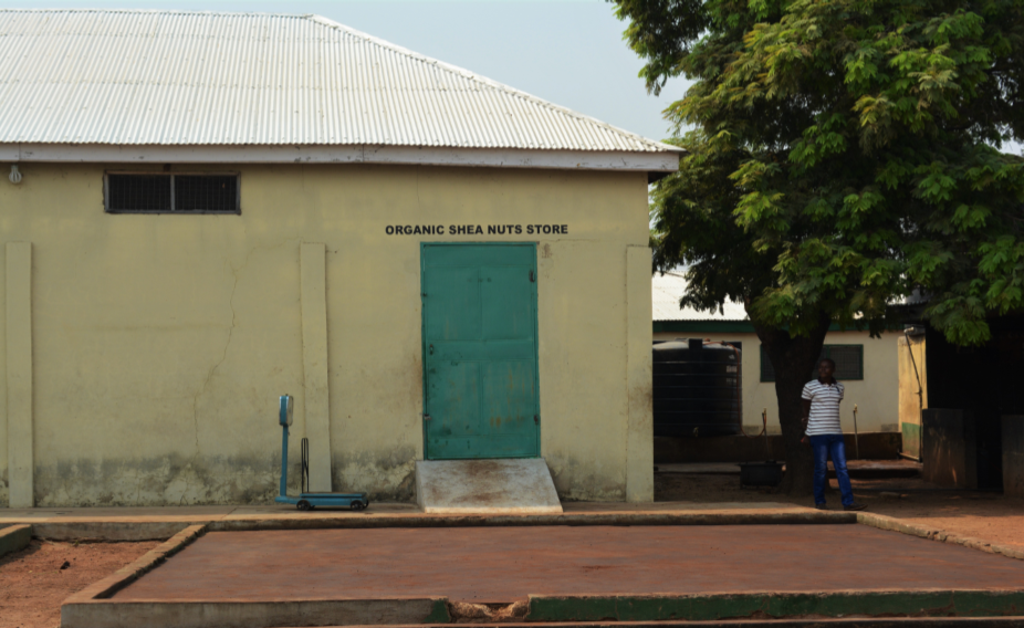 A Ghanaian hut with a green door