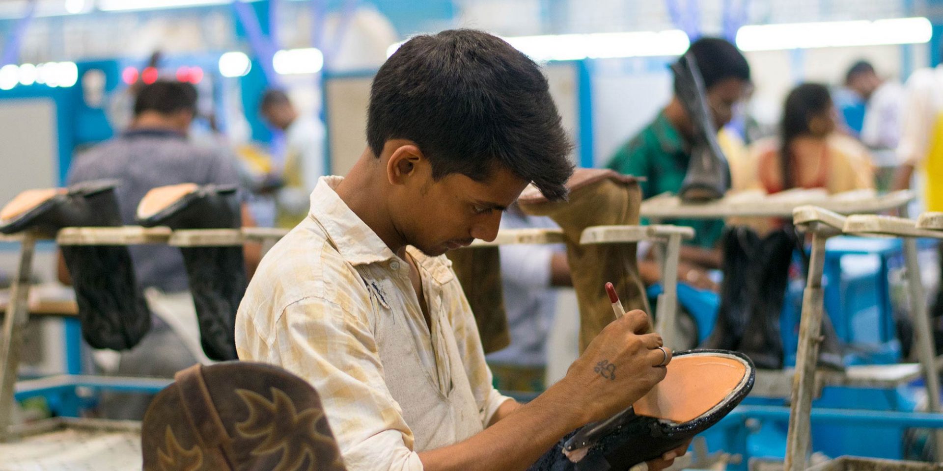 A man works on creating a shoe