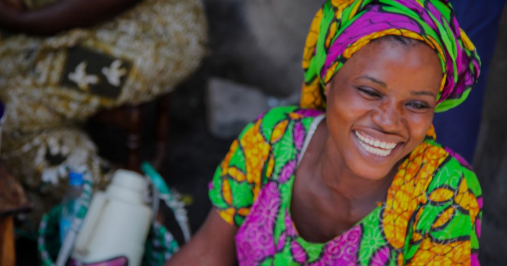 Brightly dressed women shows her smile