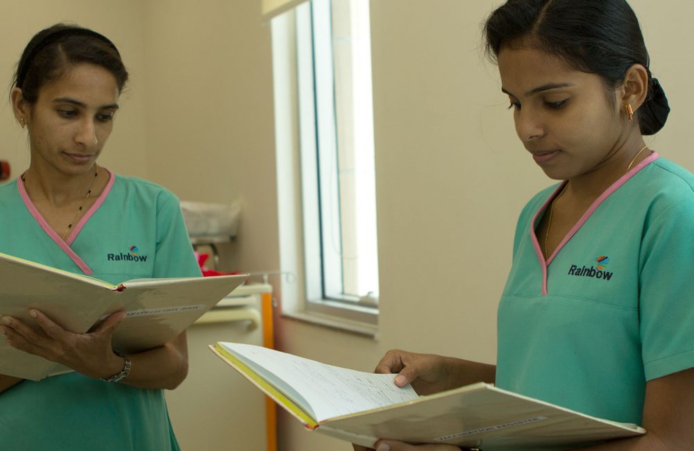 Two female Indian doctors comparing notes