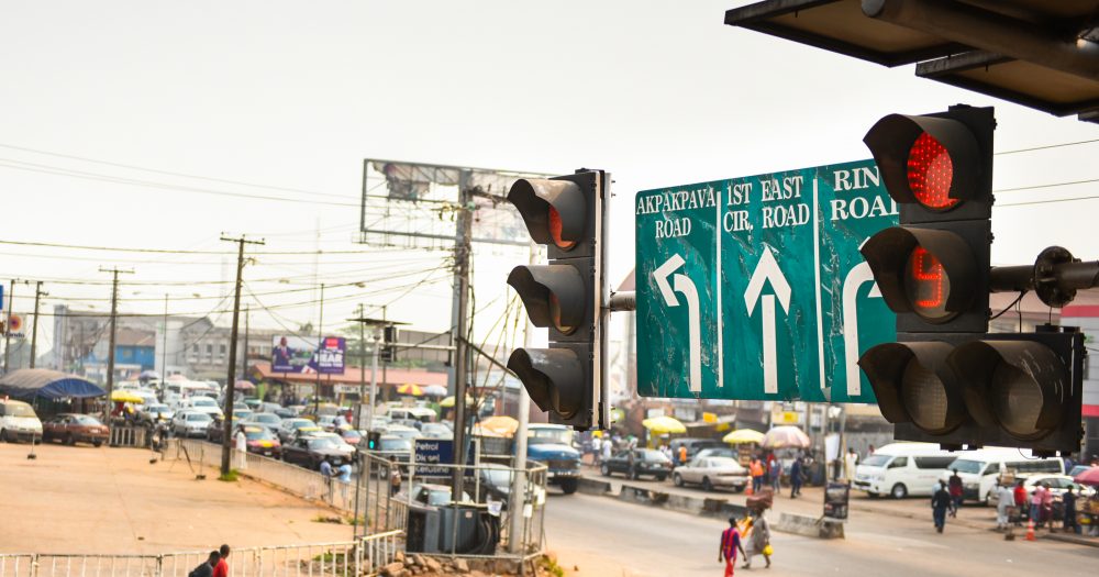 A traffic light counts down to green within the city of Benin