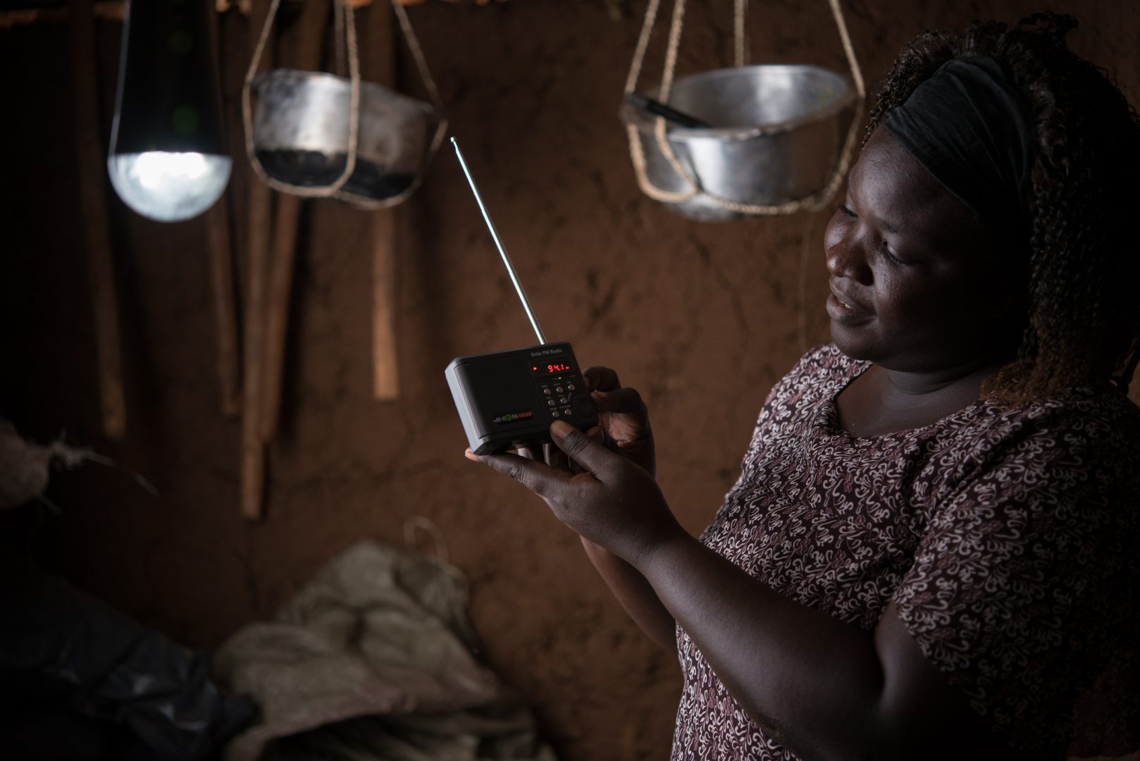 Female customer accessing energy via solar home system